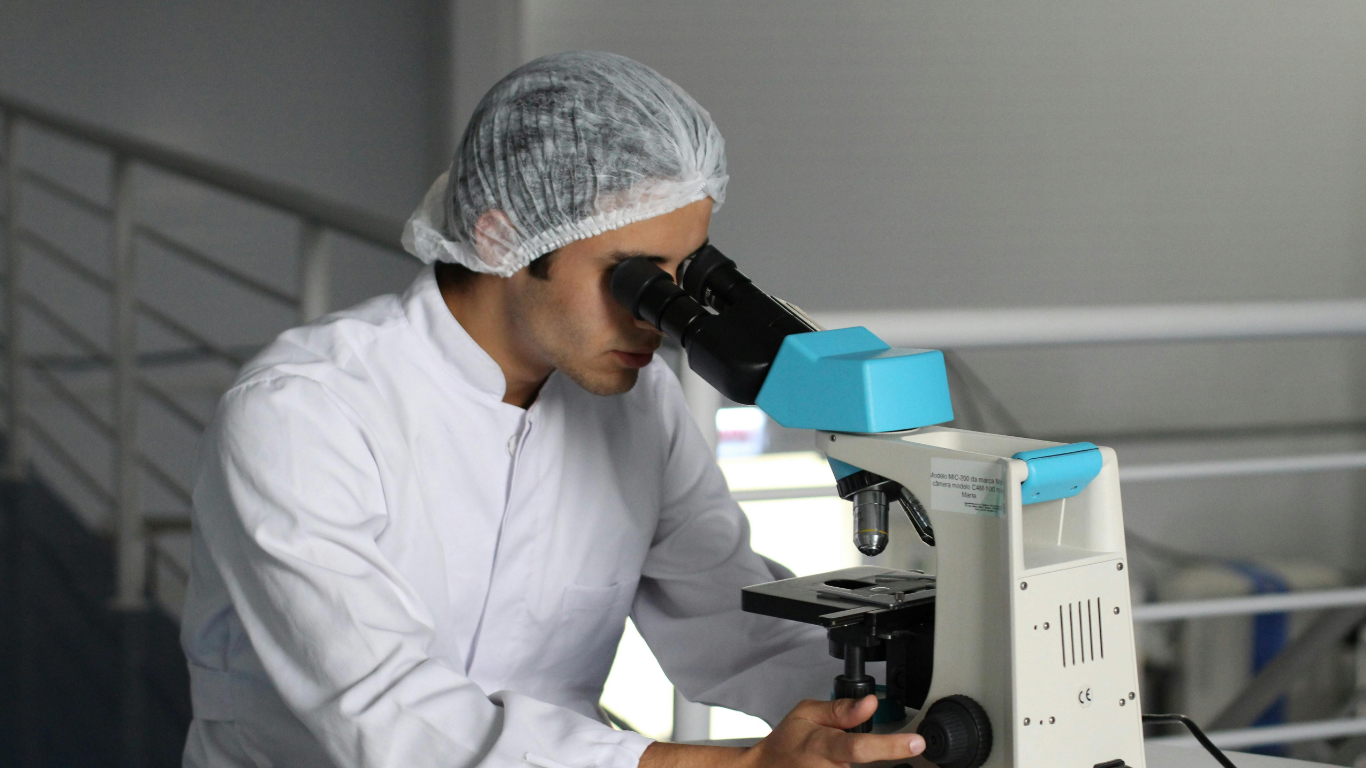 Biology student looking through a microscope