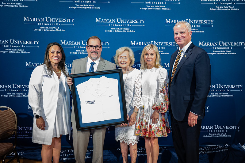 Wood Family presented with white coat by Dean Wright and President Elsener